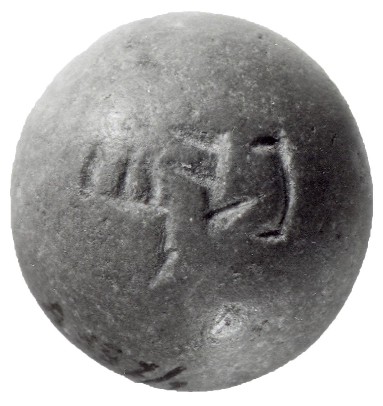 Dome-shaped stone weight with Hebrew inscription.