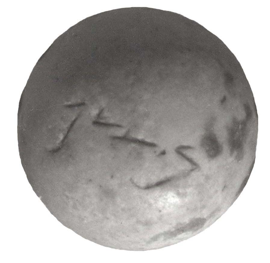 Dome-shaped stone weight with Hebrew inscription.