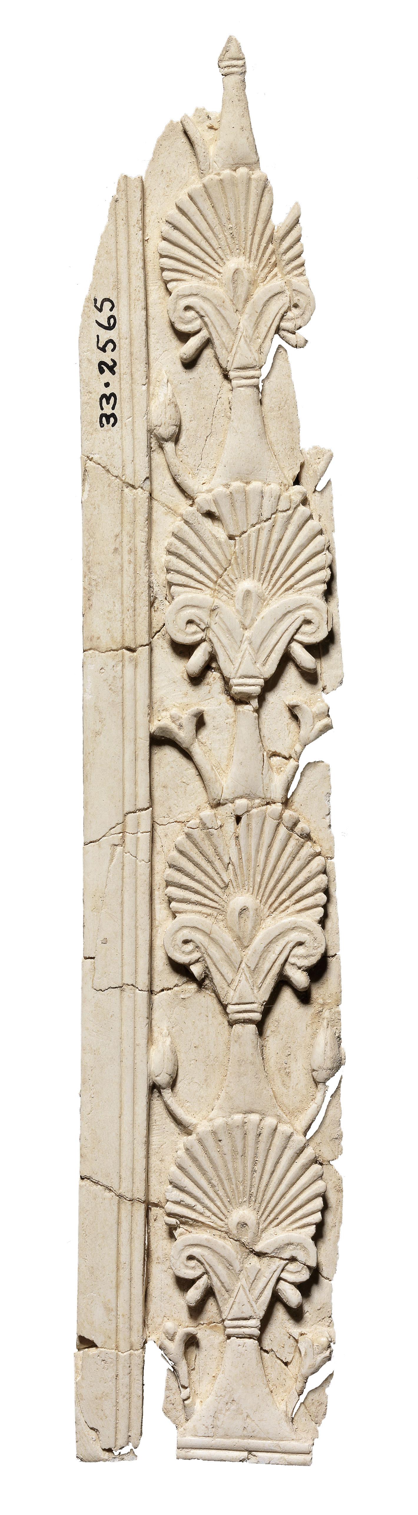 Ivory carving of a vertical series of four palmettes.