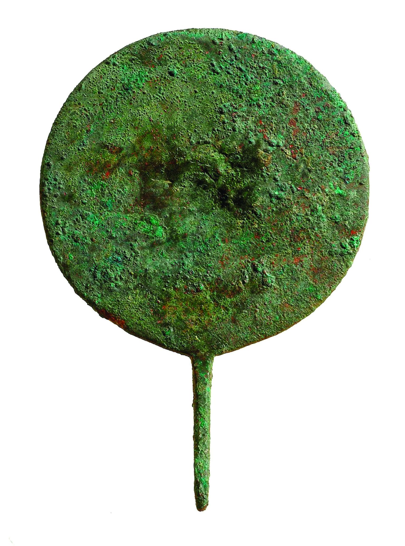 A circular metal disc with small handle.