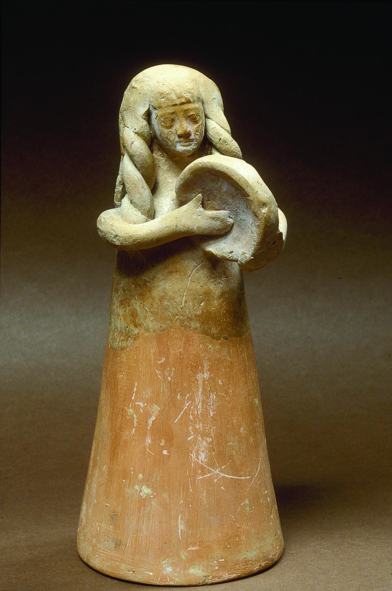 Terra-cotta figurine of women with long hair playing frame drum. 