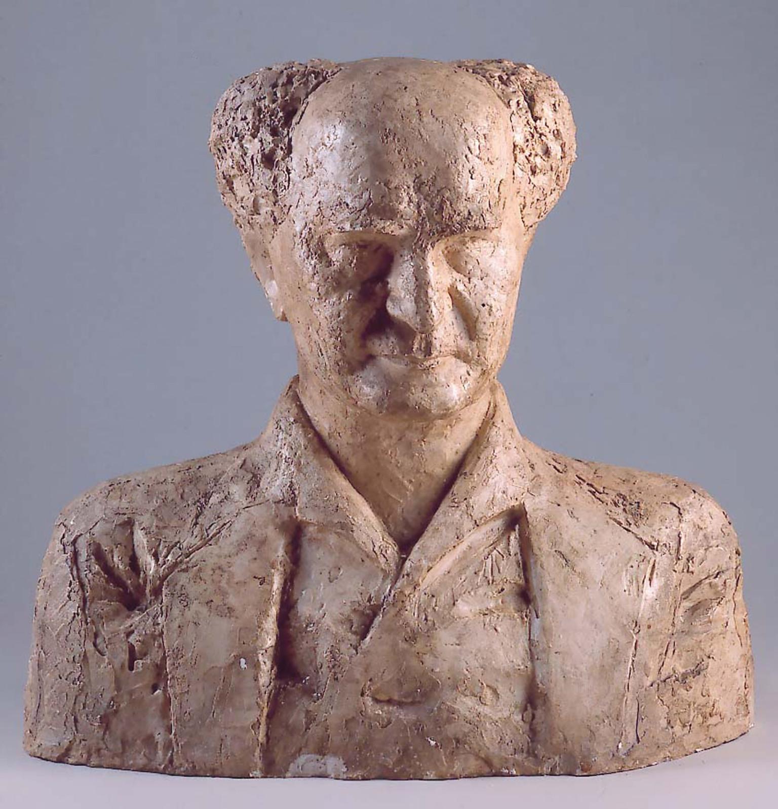 Bust sculpture of an elderly man with central bald spot facing viewer.
