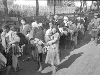 Deportation of Russian Jews Photo of a line of Jewish women carrying children and belongings.