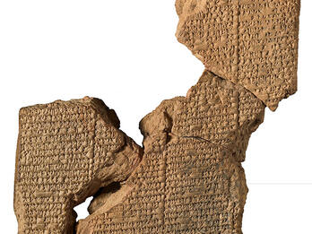 Clay tablet in several sections inscribed with Akkadian text.