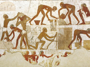 Mural of people carrying bricks, measuring blocks, and pouring buckets. 