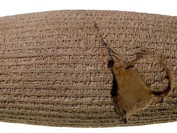 Stone cylinder inscribed with cuneiform.