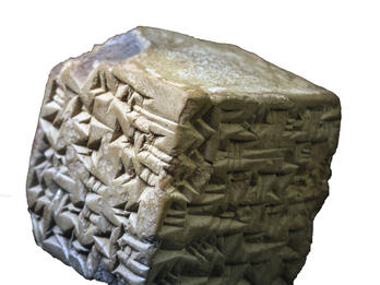 Stone cube inscribed with cuneiform. 