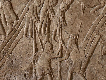 Relief of two people impaling three people. 