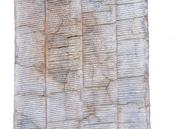 Clay tablet with cuneiform inscription.