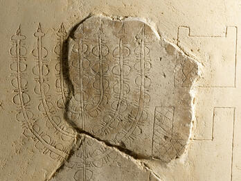 Plaster relief with image of seven-branched candelabrum. 