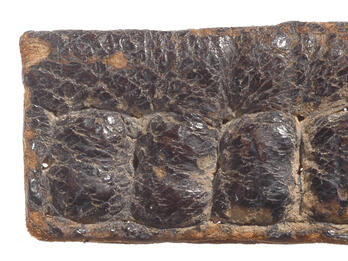 Leather capsule with four indented sections.