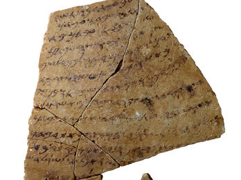 Tablet with inscribed Hebrew writing and several cracks, and small disconnected fragment.