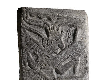 Relief of figure with six wings and headdress.