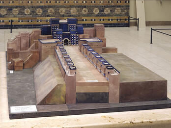 Model of temple and long avenue lined with small uniform buildings.