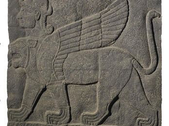 Hybrid Creature with Wings on Stone Relief Stone relief of winged lion-like figure with extra head wearing headdress.