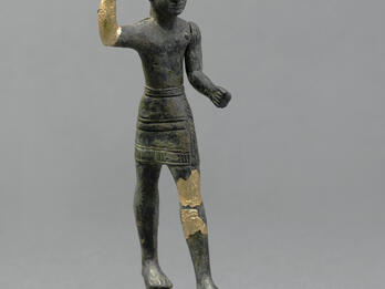 Figurine with horned helmet and raised hand, with gilded bronze on hand and thigh.
