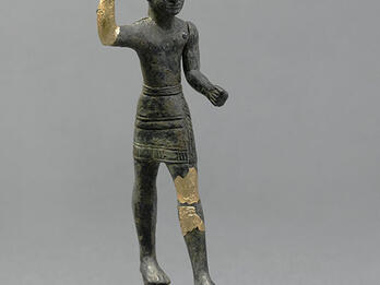 Figurine of Male Deity Figurine with horned helmet and raised hand, with gilded bronze on hand and thigh.