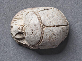 Stone cylinder resembling beetle.