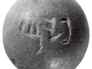 Dome-shaped stone weight with Hebrew inscription.