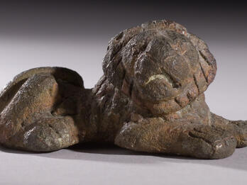 Bronze weight in shape of crouching lion.