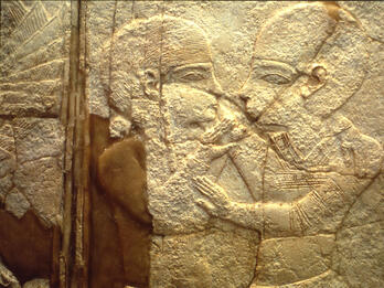 Ivory inlay of two figures in profile embracing. 