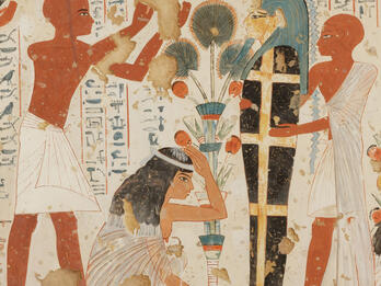 Mural of crouching woman with hand on her head next to upright mummy held up by figure in tunic, as another figure in tunic raises arms above woman, with hieroglyphic text in background. 