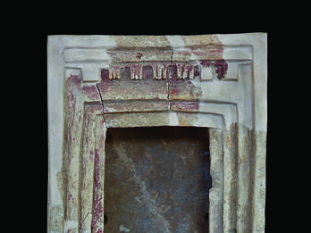 Terra-cotta shrine with capitals at entrance.