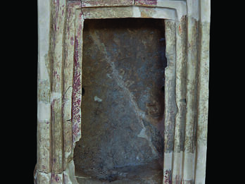 Terra-cotta shrine with capitals at entrance.