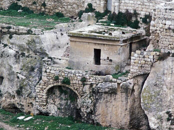 Photograph of tomb on top of stone structures.