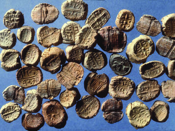 40 clay seals showing impressions of images or alphabetic inscriptions.