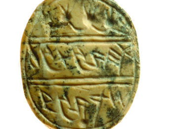 Oval seal decorated with garland and four pomegranates at top and Hebrew inscription.