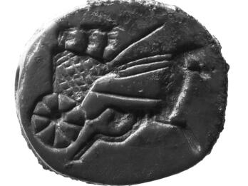 Limestone seal with image of driver and two people in a horse-drawn chariot.