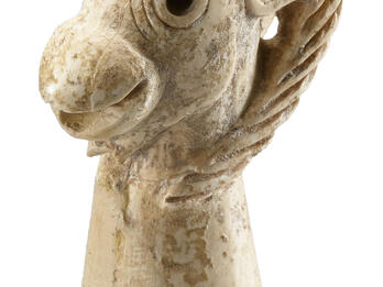 Ivory stopper in shape of ibex head with open mouth.