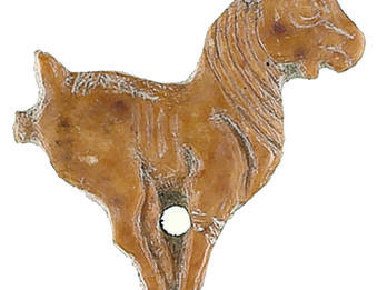 Ivory Goat Inlay Ivory sculpture of goat with feet close together and hole in center.