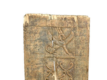 Small ivory plaque with decorative carvings of crouching winged sphinx wearing double crown and two three-tiered palmettes.