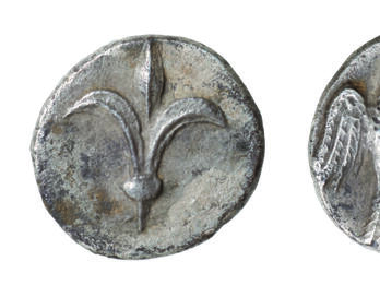 Front and back of coin, with lily on one side and falcon on the other