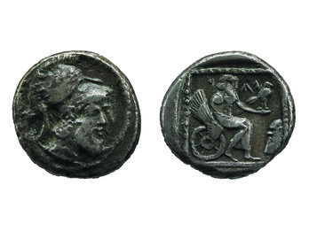 Front of coin depicting head with beard wearing helmet and back of coin depicting figure on winged chariot holding bird.