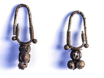 Pair of earrings with rounded attachment.