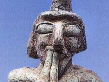 Double-pipe Player Ceramic figure playing a double pipe.