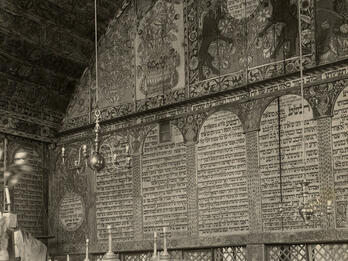 Synagogue, Bechhofen, Germany Interior of building of back wall with decorative images on top, Hebrew text in the middle, and lattice below, platform with railing in left foreground, and several podiums along wall.
