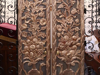 Doors to the Bimah, Rema Synagogue. Set of curved doors with carving of peacock-shaped pitcher filled with foliage and fruit extending to top of door.