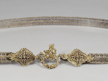 Metal belt with carved clasp.