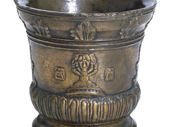 Bronze Physician’s Mortar Bronze mortar decorated with a seven-branched candelabrum, flanked with the Hebrew letters mem and resh.
