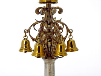 Torah Finial Finial with Hebrew inscription on its base, bells, and crown on top.