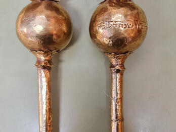 Two finials with Hebrew inscription on one. 