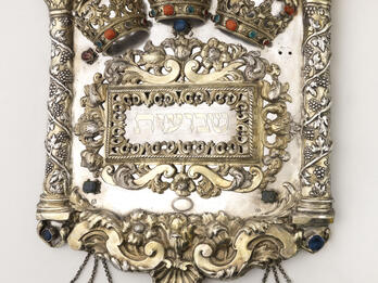 Torah Shield Torah shield decorated with vine-wrapped columns on either side, crowns across the top, and three smaller shields hanging from bottom.