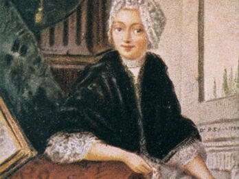Portrait of Fromet Guggenheim Image of seated woman in shawl with arm resting on a table with tablecloth.
