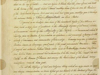 Handwritten letter in English with small stamp at top and signature on bottom.