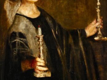Portrait of woman holding candles.
