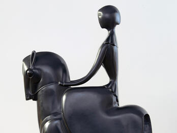 Sculpture of stylized figure on horseback.